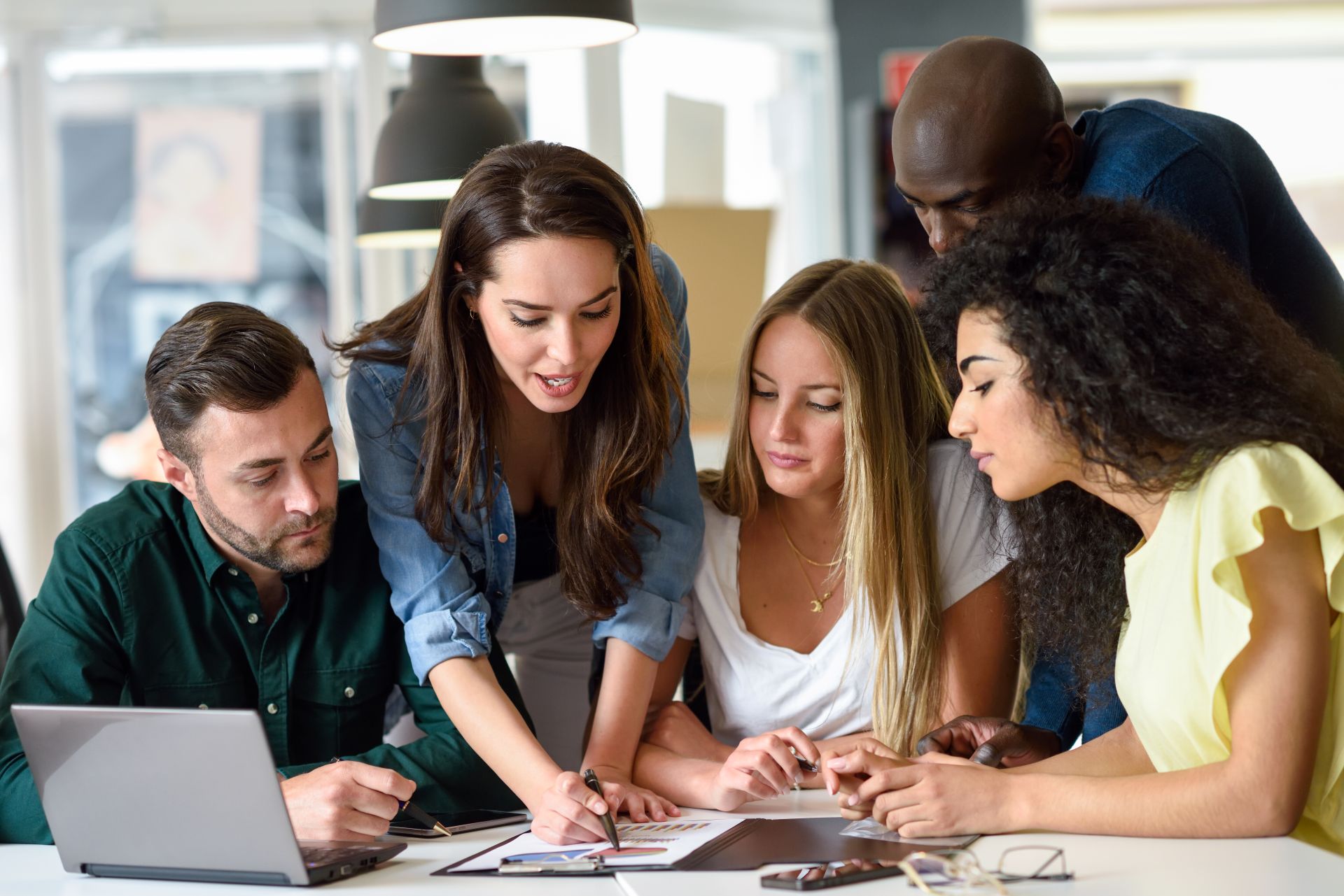 Multi-ethnic group of young men and women studying indoors